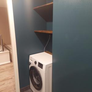 a washer and dryer in a laundry room at Trinitix apartment in Tapa +3 photos