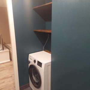 a washer and dryer in a laundry room at Trinitix apartment in Tapa