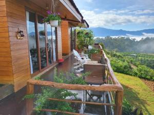 a porch of a house with a view at Tà Đùng May Farm in Biđong