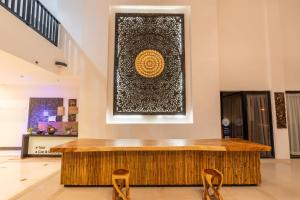 a lobby with a wooden counter and two chairs at Samaya Wellness Resort in Lamai