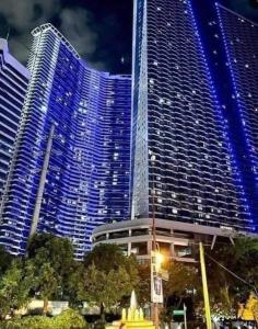 a large building with blue lights on it at Air Residence a2 @Central RCBC/Canadian Embassy in Manila