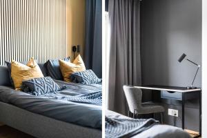 a bedroom with a bed and a table and a chair at Elite Business Suite in Nyköping