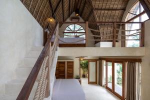 an open hallway with a staircase in a house at Lulu's Villas in Uluwatu