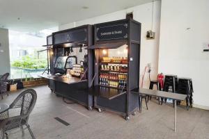 a store with a counter with bottles of alcohol at 6 Pax Regalia Suite & Residences Infinity Pool with KL City View in Kuala Lumpur