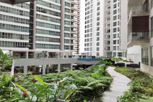 a walkway in a city with tall buildings at 6 Pax Regalia Suite & Residences Infinity Pool with KL City View in Kuala Lumpur