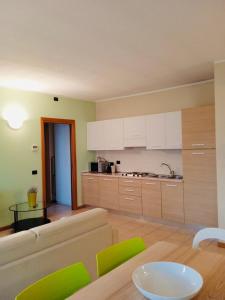 a kitchen with a couch and a table in a room at Residenza Villa in Corno Alto