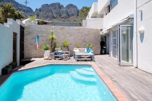 a swimming pool in the backyard of a house at Beach Steps in Cape Town