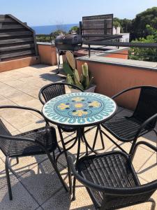 a table and chairs sitting on a patio at Sunny apartment Sa Boadella big solarium sea view in Lloret de Mar