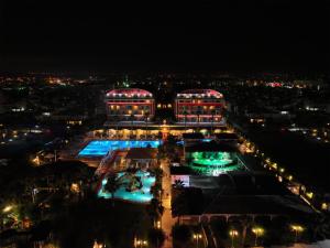 a view of a building at night with lights at Orange County Belek - Family Concept in Belek