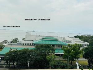 a building with a green roof in front of us embassy at Grand Riviera Suites2 @ US embassy/freepool/Wi-Fi in Manila
