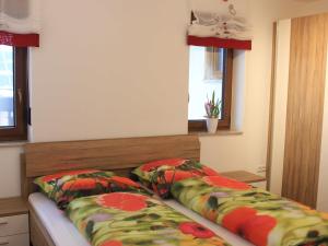 een slaapkamer met een bed en 2 kussens bij Preuschens Hof in Egloffstein