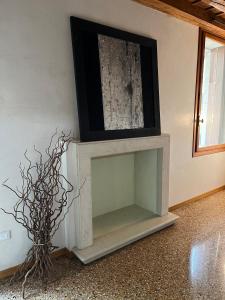 a fireplace with a tv on top of it at Il Campanile in Vicenza