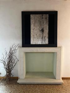 a white console table with a picture on the wall at Il Campanile in Vicenza