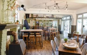a restaurant with a bar with wooden tables and chairs at Hotel Restaurant In d'Ouwe Peel in Helenaveen