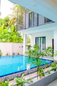 an image of a house with a swimming pool at Ceylanro Transit Villa in Negombo