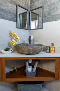 a bathroom with a sink with two mirrors on a counter at Laolabatwo in La Gaulette