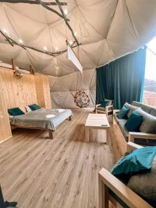 a room with a tent with a bed and a couch at Glamping Park in Khndzorut