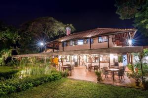 a house with tables and chairs in a yard at night at Cheerful 6BR Town House @ Geortown for 5-14pax by Cohans in George Town