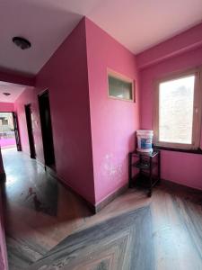 an empty room with pink walls and a window at Hotel Sweet Dreams thamel kathmandu in Kathmandu