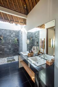 a bathroom with two sinks and a shower at Balidroomvilla's in Karangasem