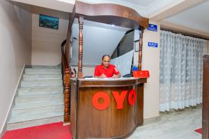 a man sitting at a podium in a room at OYO 801 Hotel View Global in Kathmandu
