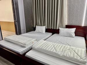 two beds sitting next to each other in a room at Thien Phuc Hotel in Ba Tri