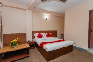 En eller flere senge i et værelse på OYO 801 Hotel View Global