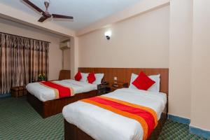 Una cama o camas en una habitación de OYO 801 Hotel View Global