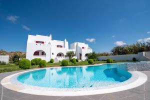 a villa with a swimming pool in front of a house at Depis Edem luxury villas naxos in Plaka