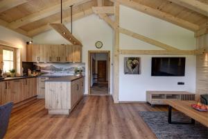 a large kitchen with wooden cabinets and a table at Holznerhof - Chiemgau Karte in Inzell