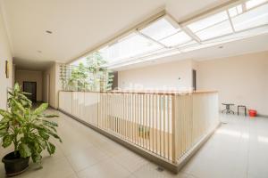 a large room with a balcony with a skylight at Palm Eight Mitra RedDoorz in Jakarta