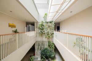 a hallway with plants on the wall at Palm Eight Mitra RedDoorz in Jakarta