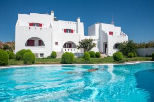 a villa with a swimming pool in front of a building at Depis Edem luxury villas naxos in Plaka