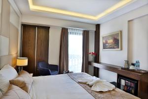 a hotel room with a bed and a window at Grand Sagcanlar Hotel in Istanbul