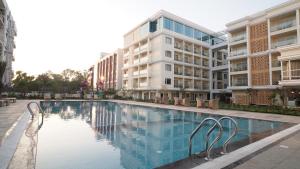 a large swimming pool in front of a building at Antique Regency in Digha