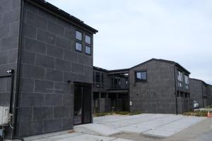 a black brick building with a building at プラフィーノリゾートヴィラ in Ise