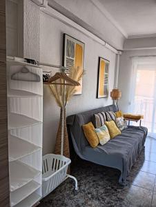 a living room with a couch and a shelf at Sunny holidays in Santa Pola in Santa Pola