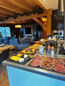 a buffet with many different types of food on a counter at Chambres et table d'hôtes au chalet Datcha in Briançon