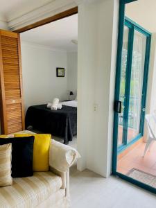 a room with a couch and a bed and a mirror at Aruba Beach Resort in Gold Coast