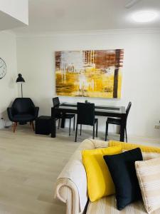 a living room with a couch and a table at Aruba Beach Resort in Gold Coast