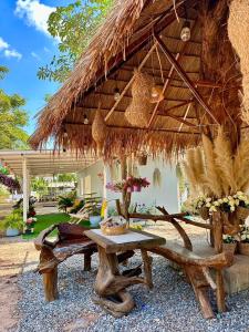 a straw hut with a table and a bench at Peang Tara Cafe & Resort in Nong Khai +76 photos