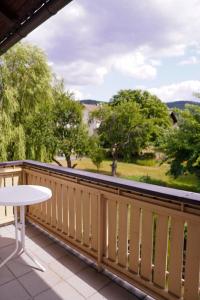 einen Balkon mit einem Tisch und Blick auf die Bäume in der Unterkunft Ferienhaus Falkenstein in Frauenau