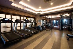 a gym with treadmills and ellipticals in a room at Orange County Belek in Belek