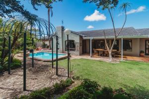 a house with a swimming pool in a yard at Rusgenot- perfect family home in George