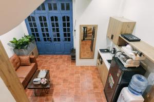 a small kitchen with a blue door and a couch at Hi-Home HanoiCenter Big Group-4BRs 2mins to HoanKiem Lake in Hanoi