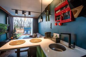 a kitchen with a sink and a living room at Sapanca Glamping in Sakarya