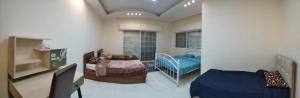 a room with a bedroom with a bed and a bed at The Oaks in Madaba