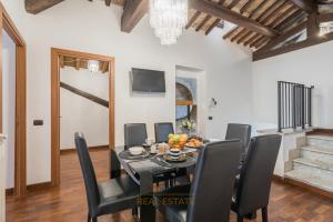 uma sala de jantar com mesa e cadeiras pretas em Apartment by The Spanish Steps em Roma