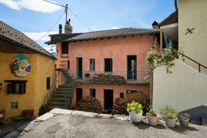 a house with a staircase in front of it at Wild Valley Puro Ticino 1+2 in Valle Onsernone in Crana