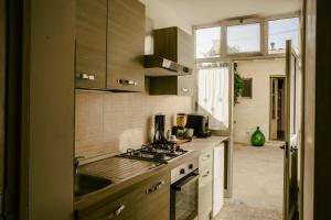 a kitchen with a sink and a stove top oven at Le 3 Volte in Cursi